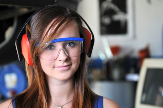 Junge Frau mit Gehörschutz und Schutzbrille