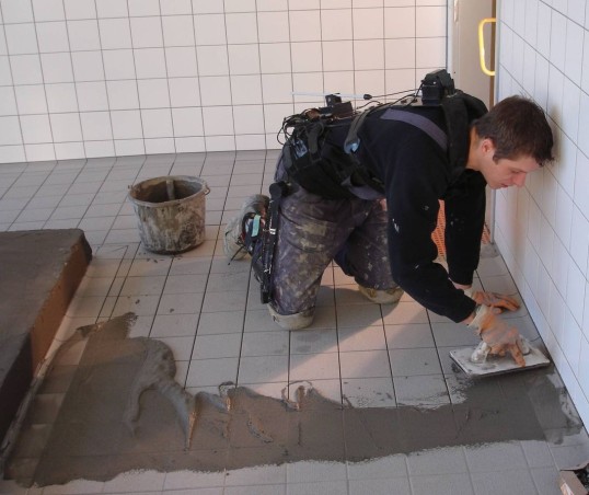 Floor tiler at work