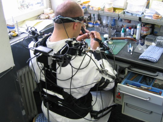 Dental technician at his workplace, seen from behind