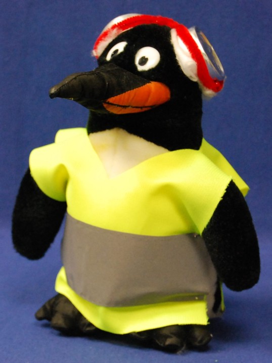Stuffed penguin with warning vest and hearing protection