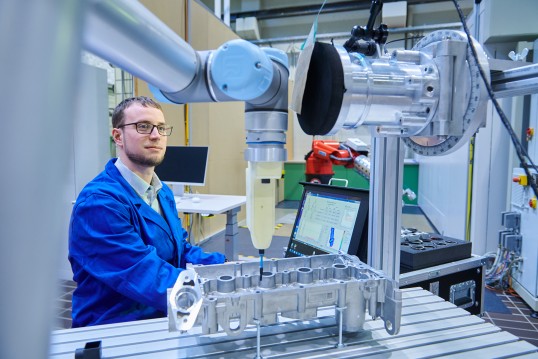 IFA scientist with robot and force measuring device