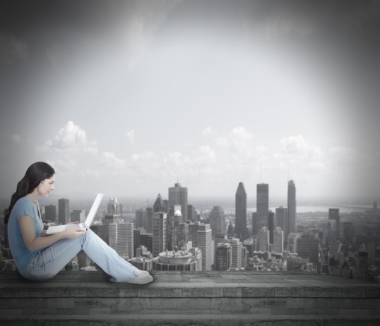 Woman holding a notebook on her knees