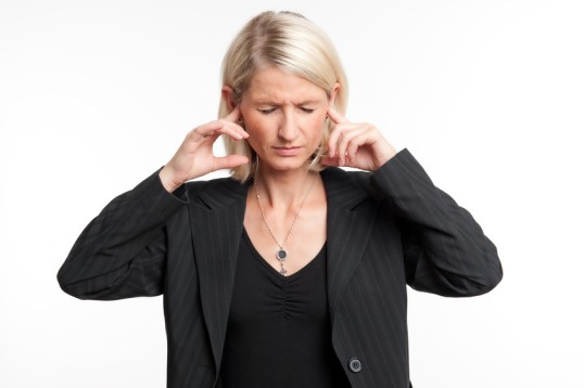 Woman blocks her ears