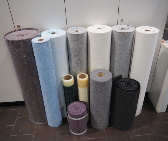 A dozen rolls of felt, plastic and other materials