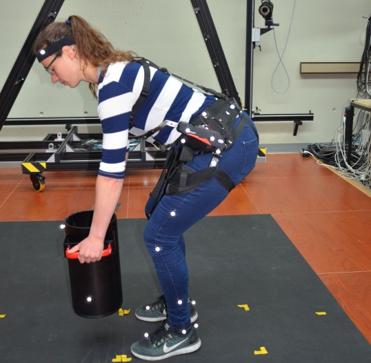 Woman with hip belt / harness lifting a load