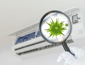 Luftfilter mit einer Lupe und einer vergrößerten Virusdarstellung