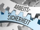 Bild von Zahnrädern mit der Aufschrift: Arbeits-Sicherheit.