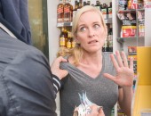 Foto: eine Kassiererin wird von einem Kunden bedroht