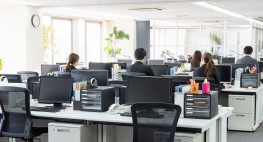 Großraumbüro mit mehreren Arbeitsplätzen.